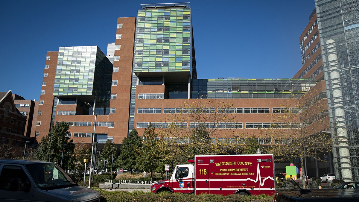 A Baltimore County Fire Department ambulance travels past the entrance of The Johns Hopkins Hospital in Baltimore, Maryland, on Friday, Nov. 20, 2020. Dr. Eric Kossoff from John Hopkins in Balitmore helped one family whose daughter suffers from epilepsy.