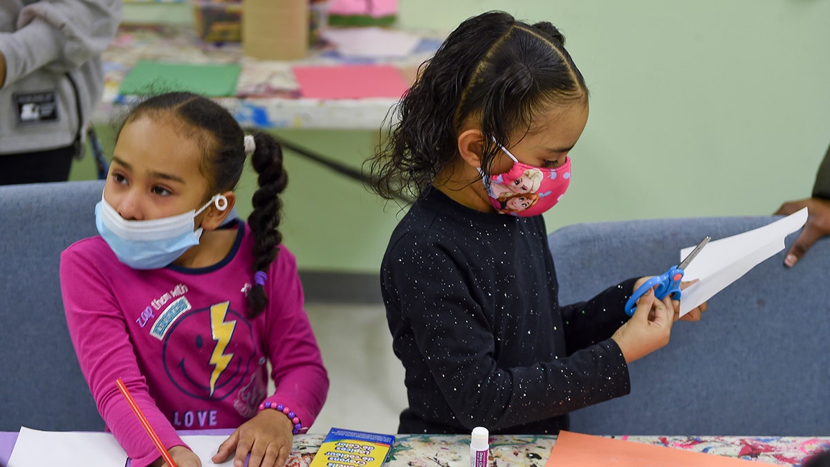 Kamil Esteves, 6, and Laynette Padilla, 6, make thank you cards to be sent to healthcare workers. Recently, a Pennsylvania court tossed out a mask mandate for schools. 