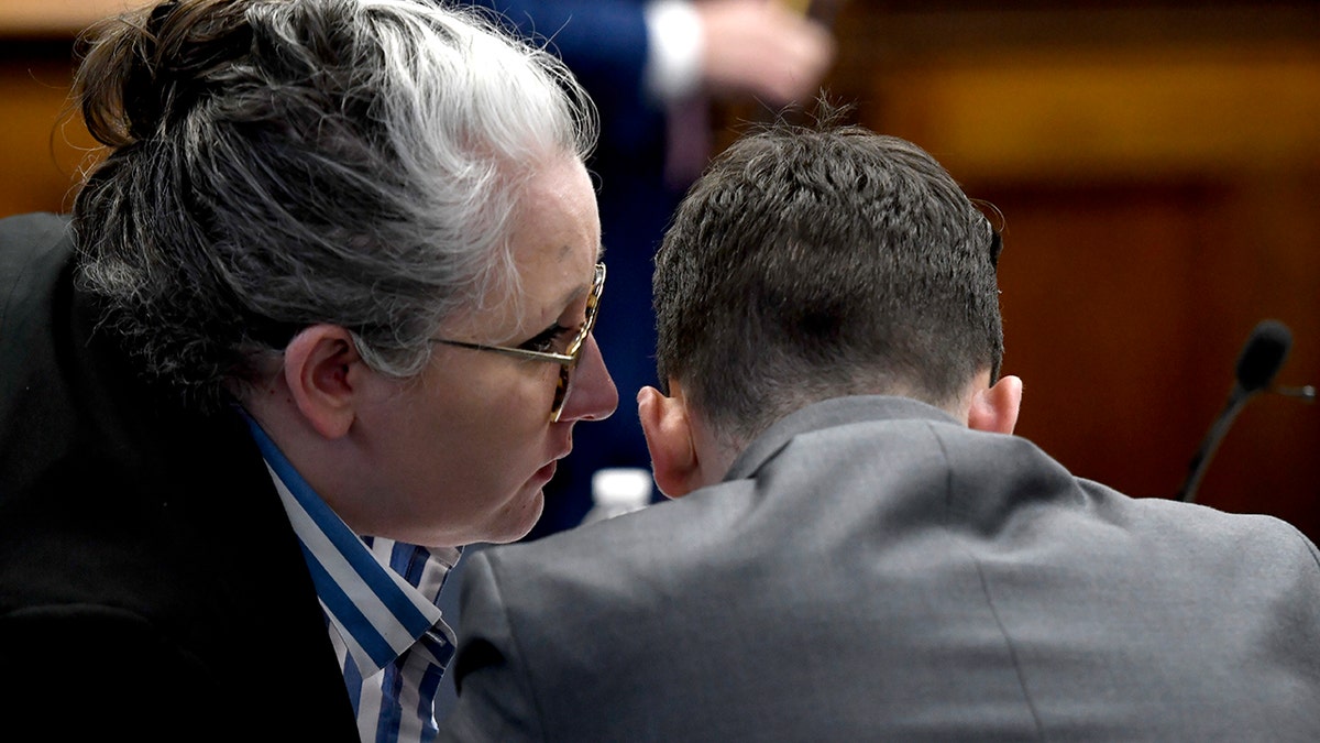 Kyle Rittenhouse, right, receives a message from one of his attorneys, Natalie Wisco, during the jury selection process of his trial at the Kenosha County Courthouse in Kenosha, Wisconsin, on Nov. 1, 2021.