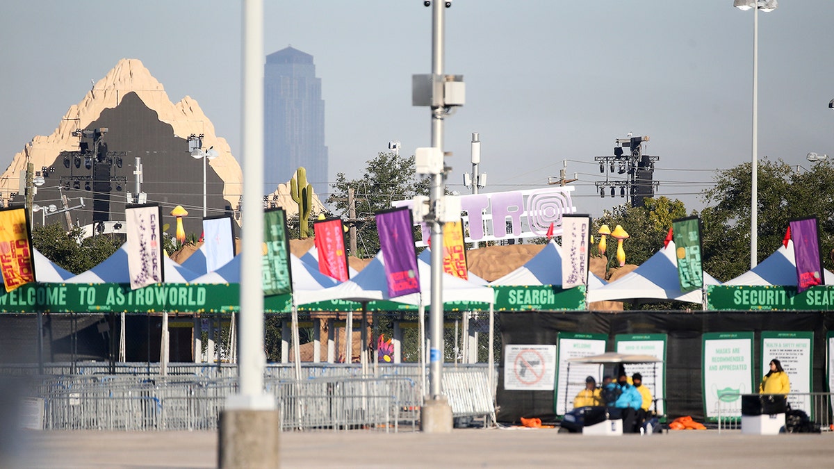 Security walks around the NRG lots where Astroworld was held the night before in Houston on Saturday.  