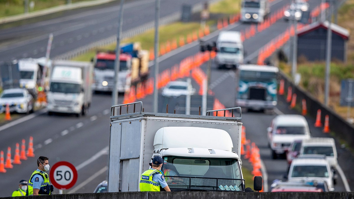 Police inspect vehicles at a road block on the outskirts of Auckland, New Zealand on Oct. 27, 2021. 