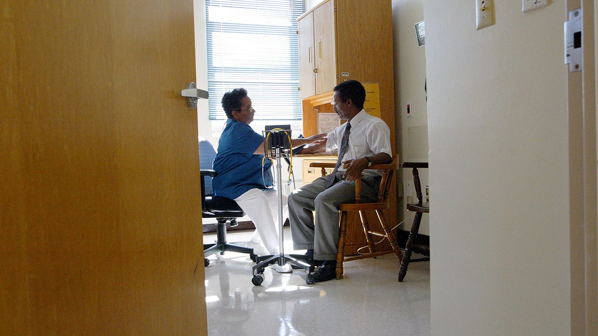 Nurse Melba Benedict (L) checks Negash Berhe's blood pressure July 9, 2003 at Highland Hospital in Oakland, California. Recently, reports show that nearly one-fifth of adults with hypertension are taking medication that increases blood pressure.