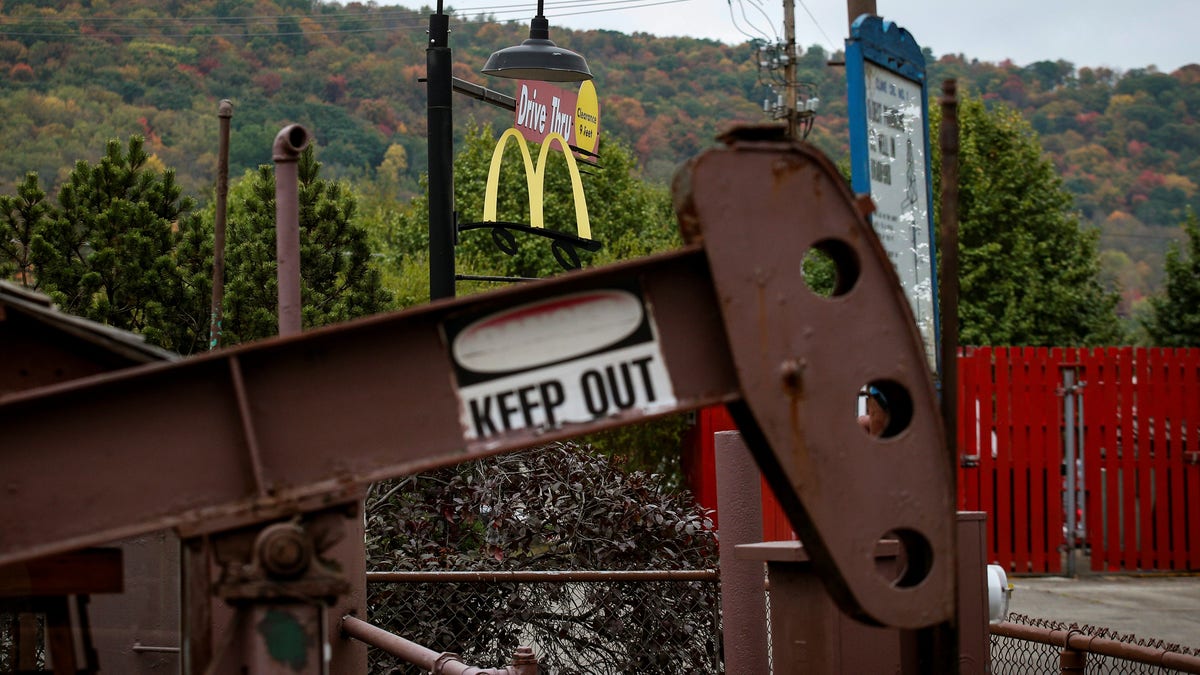 An oil pumpjack operates in the drive-thru area of a McDonald's in Bradford, Pennsylvania, U.S. October 6, 2017. REUTERS/Brendan McDermid
