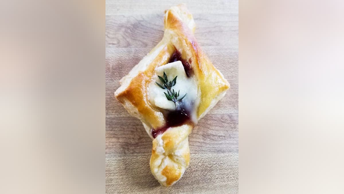 Trendgredient's cranberry brie tarts are made with fruit jam or sauce, cheese, eggs and thyme.