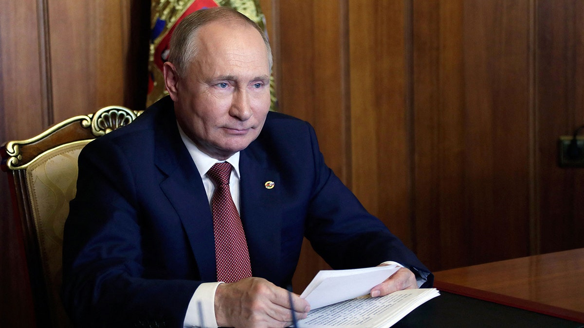 Russia's President Vladimir Putin attends a meeting of the Supreme State Council of the Union State of Russia and Belarus on Unity Day, via teleconference call, in Sevastopol, Crimea, on Nov. 4, 2021. One journalist is suggesting that Putin was effectively blackmailed by the president of Belarus over the migrant crisis.