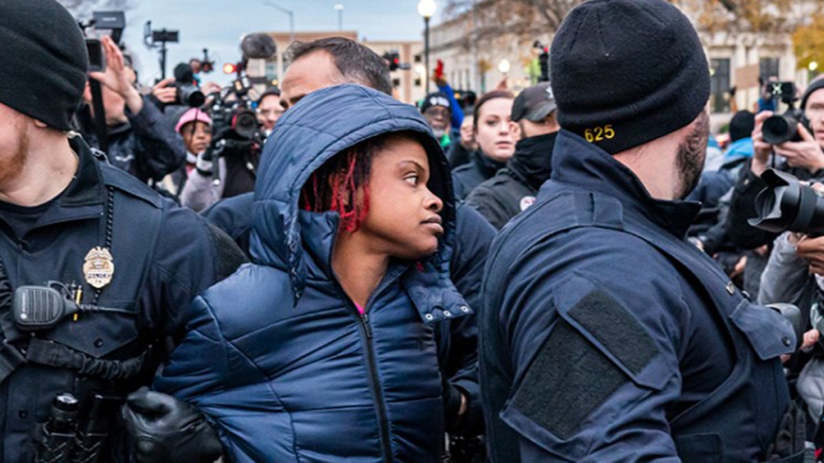 Kenosha Police arrest Shaquita Cornelious, 34, who is in favor of conviction in front of the Kenosha County Courthouse while the jury deliberates the Kyle Rittenhouse trial on November 17, 2021 in Kenosha, Wisconsin.