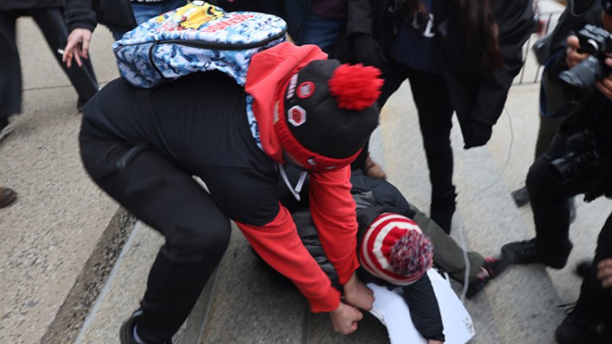 Demonstrators with opposing views get into a skirmish outside of the Kenosha County Courthouse as the jury deliberates for a second day in the trial of Kyle Rittenhouse on November 17, 2021 in Kenosha, Wisconsin. (Photo by Scott Olson/Getty Images)