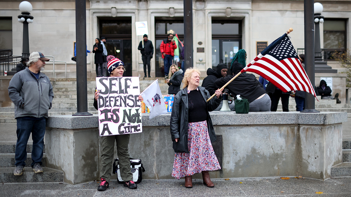 KENOSHA, WISCONSIN - NOVEMBER 17: Demonstrators gather outside of the Kenosha County Courthouse as the jury deliberates for a second day in the trial of Kyle Rittenhouse on November 17, 2021 in Kenosha, Wisconsin. Rittenhouse, a teenager, faces homicide charges and other offenses in the fatal shootings of Joseph Rosenbaum and Anthony Huber and for shooting and wounding of Gaige Grosskreutz during unrest in Kenosha that followed the police shooting of Jacob Blake in August 2020. (Photo by Scott Olson/Getty Images)