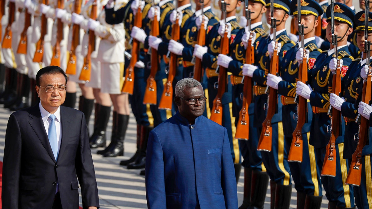Chinese Premier Li Keqiang, left, and Solomon Islands Prime Minister Manasseh Sogavare review an honor guard during a welcome ceremony at the Great Hall of the People in Beijing on Wednesday, Oct. 9, 2019. 