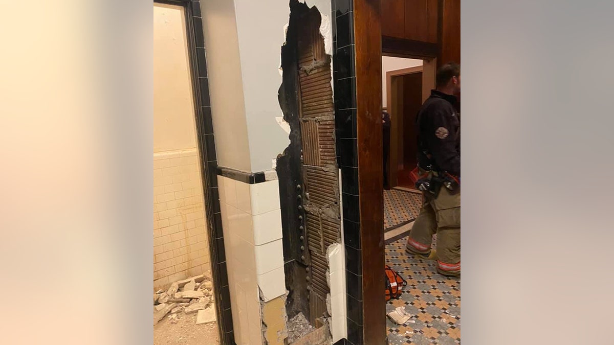 Firefighters in upstate New York on Friday rescued a naked man who was stuck for several days inside the bathroom wall of a theater, fire officials said.