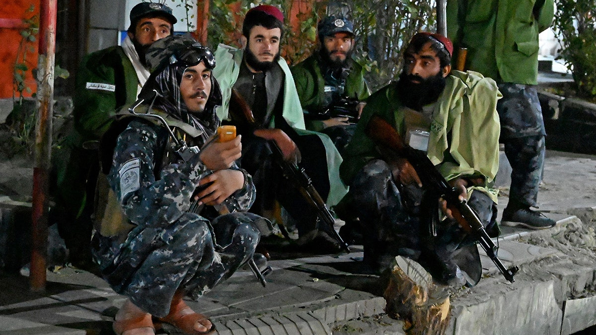 Taliban fighters sit along the roadside near Sardar Mohammad Dawood Khan military hospital in Kabul on Nov. 2 after people were killed and wounded in an attack on a military hospital. 
