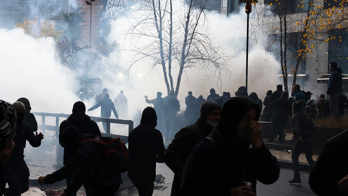A protestors clash with riot police during a demonstration against the reinforced measures of the Belgium government to counter the latest spike of the coronavirus in Brussels, Belgium, Sunday, Nov. 21, 2021.