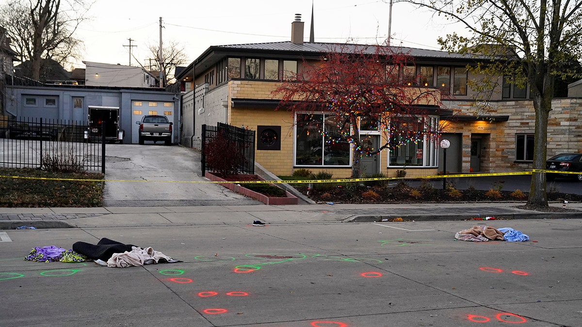 Crime scene evidence circled in spray paint is seen on Main Street the morning after a car plowed through a holiday parade in Waukesha, Wisconsin.