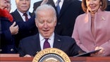 U.S. President Joe Biden celebrates with lawmakers including ‪House Speaker Nancy Pelosi (D-CA) before signing the Infrastructure Investment and Jobs Act on the South Lawn at the White House in Washington, U.S. November 15, 2021.  REUTERS/Jonathan Ernst     TPX IMAGES OF THE DAY