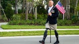 Brian Mast walking with flag