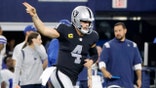 Las Vegas Raiders quarterback Derek Carr celebrates running the ball for a first down in the second half of an NFL football game against the Dallas Cowboys in Arlington, Texas, Thursday, Nov. 25, 2021.