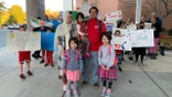 Classmates and local families greet daughters of Afghan interpreter.
