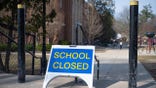 A "closed" sign in front of a public elementary school in Grand Rapids, Michigan in March 2020.