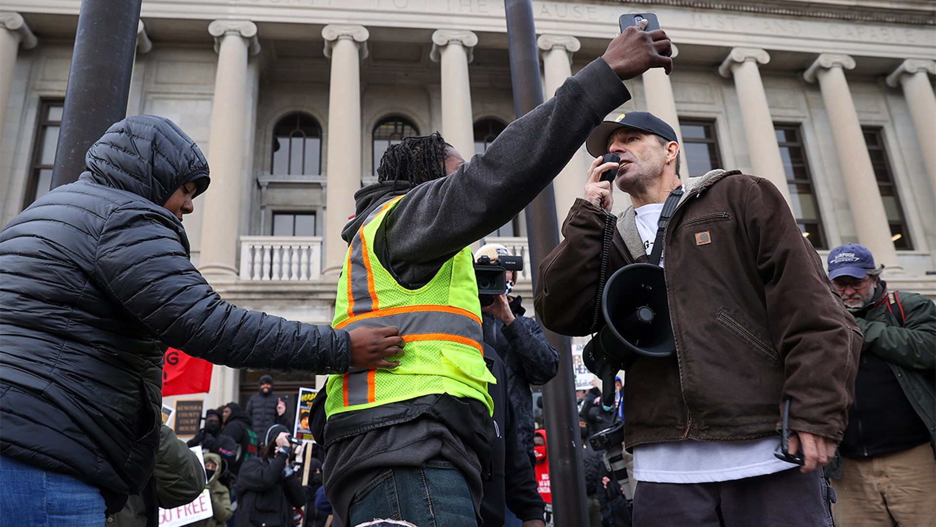 KENOSHA, WISCONSIN - NOVEMBER 16: BLM protesters and Kyle Rittenhouse supporters are confronted outside of the Kenosha County Courthouse on closing arguments in the Kyle Rittenhouse trial in Kenosha, Wisconsin, United States on November 16, 2021. (Photo by Tayfun Coskun/Anadolu Agency via Getty Images)