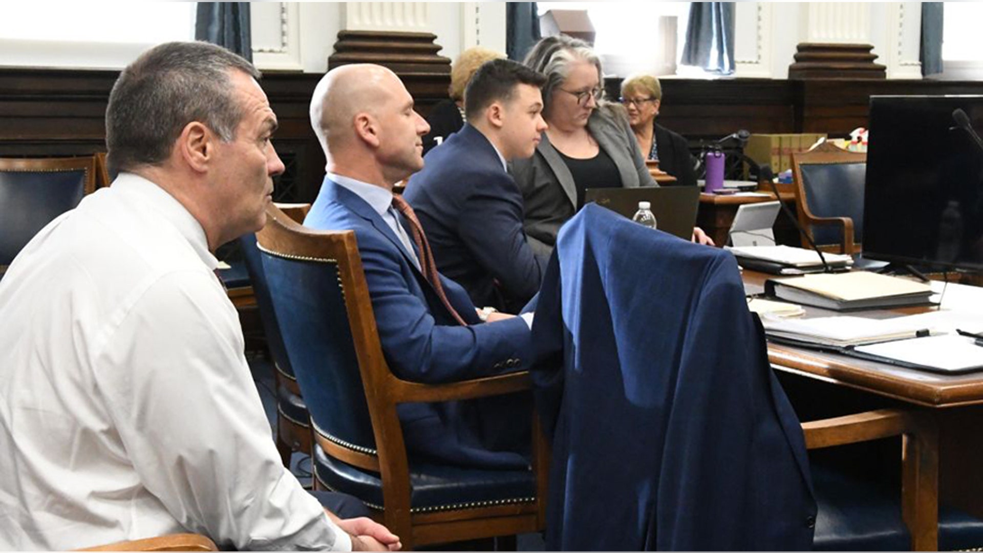 KENOSHA, WISCONSIN - NOVEMBER 10: Kyle Rittenhouse (3rd L) sits with his defense team, Mark Richards (L), Corey Chirafisi (2nd L) and Natalie Wisco during his trial at the Kenosha County Courthouse on November 10, 2021 in Kenosha, Wisconsin. Rittenhouse shot three demonstrators, killing two of them, during a night of unrest that erupted in Kenosha after a police officer shot Jacob Blake seven times in the back while police attempted to arrest him in August 2020. Rittenhouse, from Antioch, Illinois, was 17 at the time of the shooting and armed with an assault rifle. He faces counts of felony homicide and felony attempted homicide. (Photo by Mark Hertzberg-Pool/Getty Images)