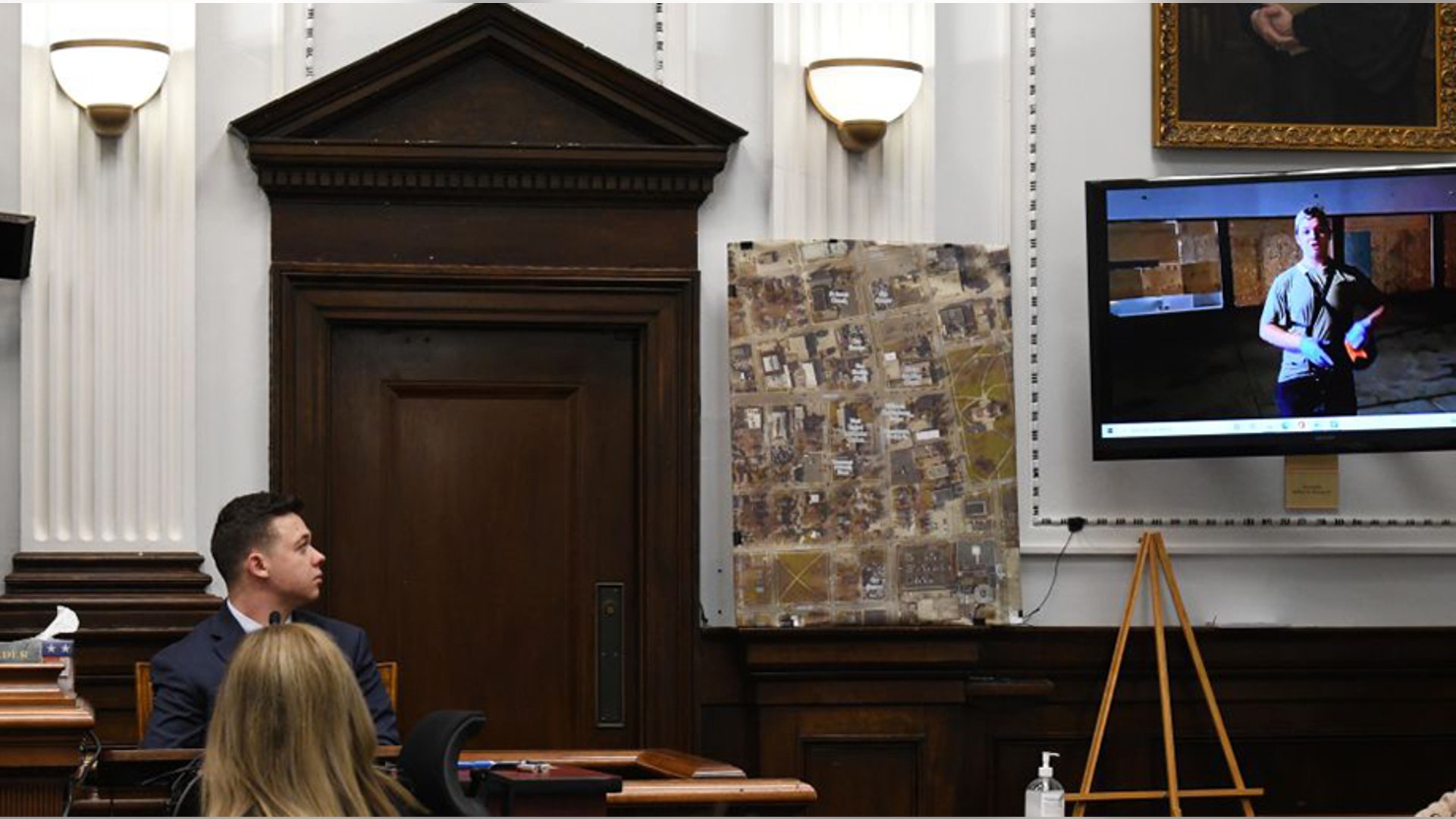 KENOSHA, WISCONSIN - NOVEMBER 10: Kyle Rittenhouse watches video of himself on the night of the shootings during cross examination while testifying at his trial at the Kenosha County Courthouse on November 10, 2021 in Kenosha, Wisconsin. Rittenhouse shot three demonstrators, killing two of them, during a night of unrest that erupted in Kenosha after a police officer shot Jacob Blake seven times in the back while police attempted to arrest him in August 2020. Rittenhouse, from Antioch, Illinois, was 17 at the time of the shooting and armed with an assault rifle. He faces counts of felony homicide and felony attempted homicide. (Photo by Mark Hertzberg-Pool/Getty Images)