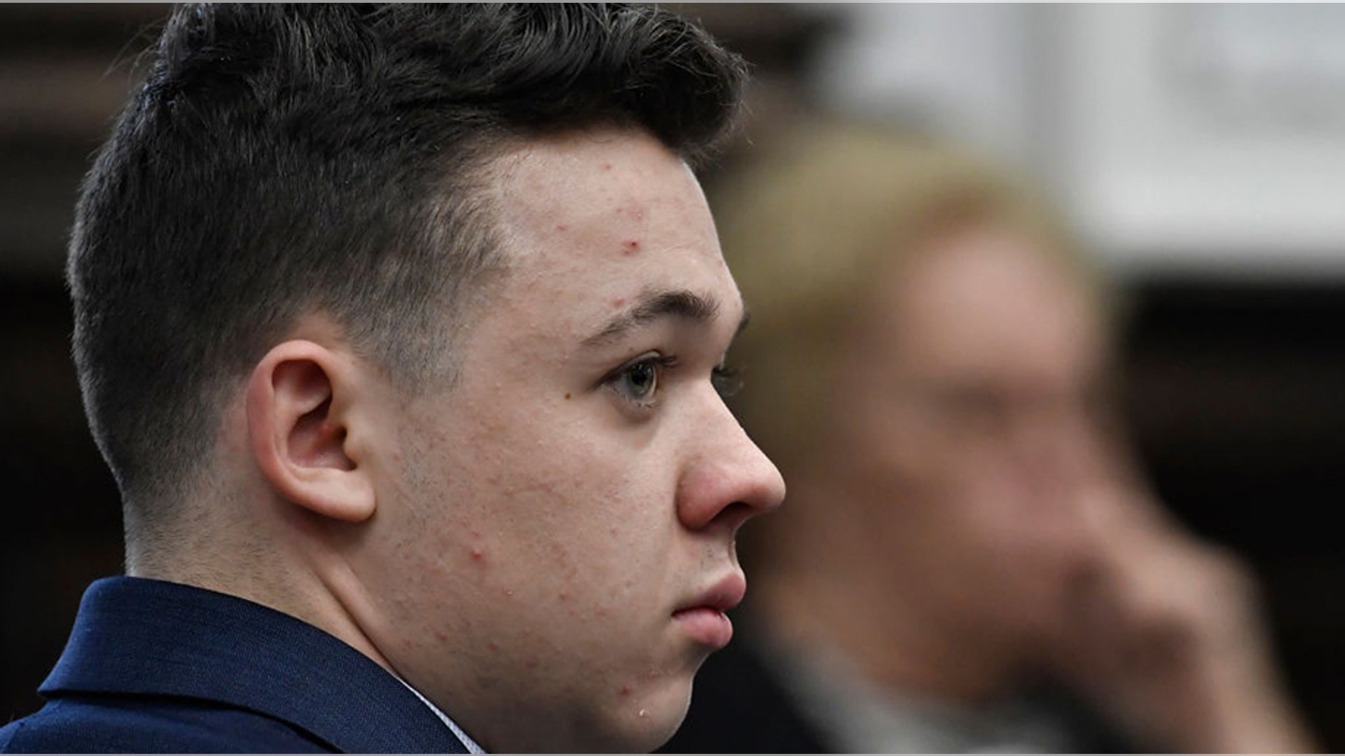 KENOSHA, WISCONSIN - NOVEMBER 10:  Kyle Rittenhouse listens as Assistant District Attorney Thomas Binger attempts to introduce evidence that was previously blocked by Judge Schroeder during his trial at the Kenosha County Courthouse on November 10, 2021 in Kenosha, Wisconsin. Rittenhouse is accused of shooting three demonstrators, killing two of them, during a night of unrest that erupted in Kenosha after a police officer shot Jacob Blake seven times in the back while being arrested in August 2020. Rittenhouse, from Antioch, Illinois, was 17 at the time of the shooting and armed with an assault rifle. He faces counts of felony homicide and felony attempted homicide. (Photo by Sean Krajacic-Pool/Getty Images)