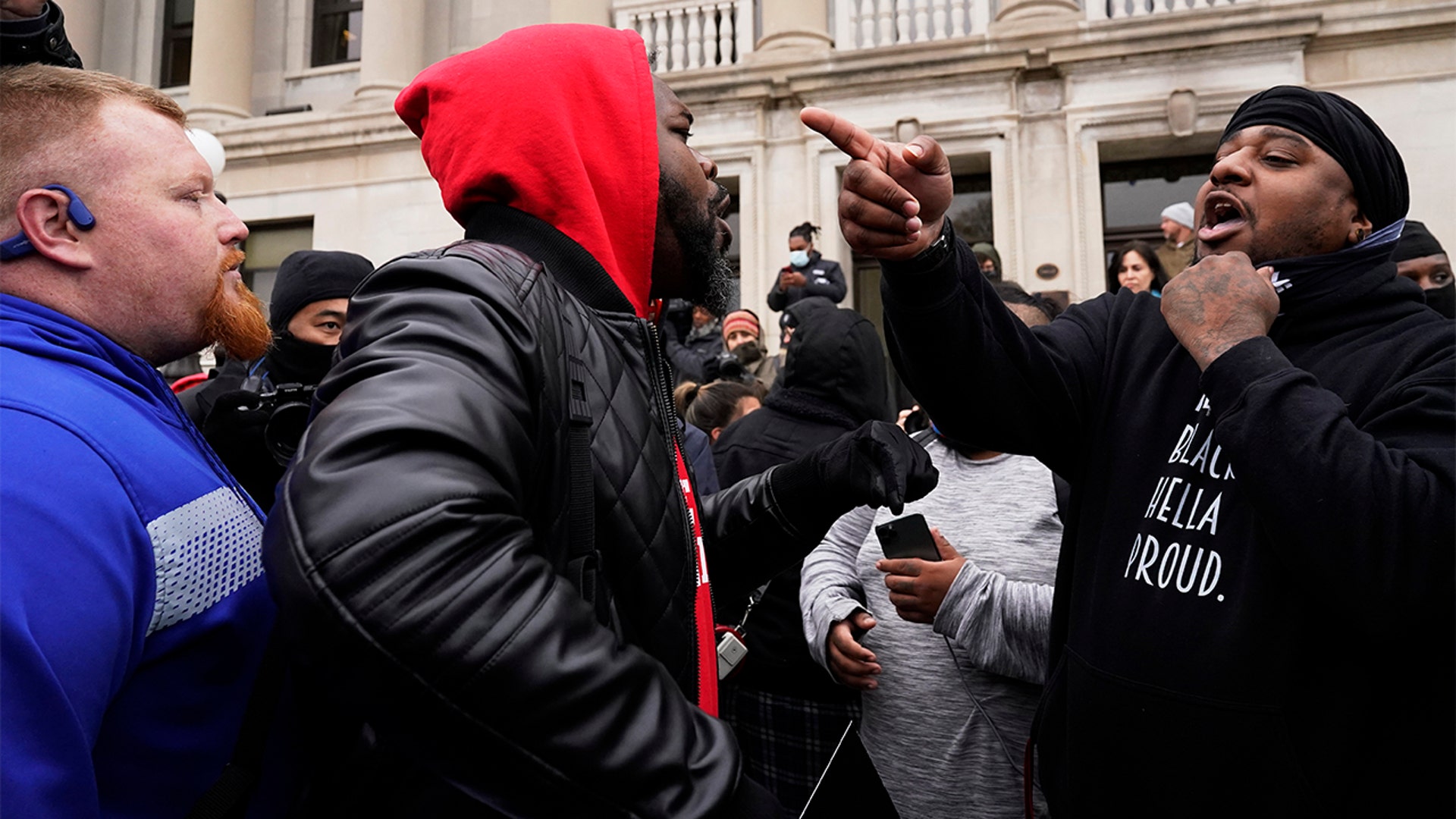 Protesters argue outside the Kenosha County Courthouse, Tuesday, Nov. 16, 2021 in Kenosha, Wis., during the Kyle Rittenhouse murder trial. Rittenhouse is accused of killing two people and wounding a third during a protest over police brutality in Kenosha, last year. (AP Photo/Nam Y. Huh)