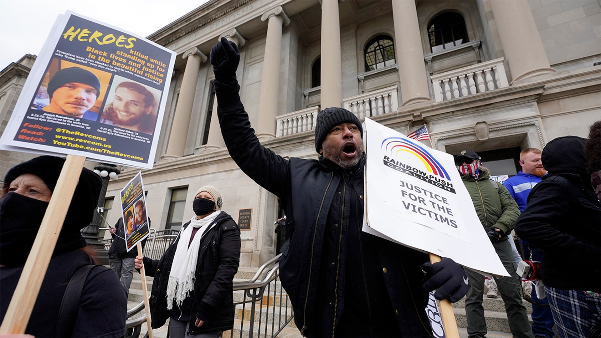 Protesters rally outside the Kenosha County Courthouse, Tuesday, Nov. 16, 2021, in Kenosha, Wis., during the Kyle Rittenhouse murder trial. Rittenhouse is accused of killing two people and wounding a third during a protest over police brutality in Kenosha, last year. (AP Photo/Paul Sancya)