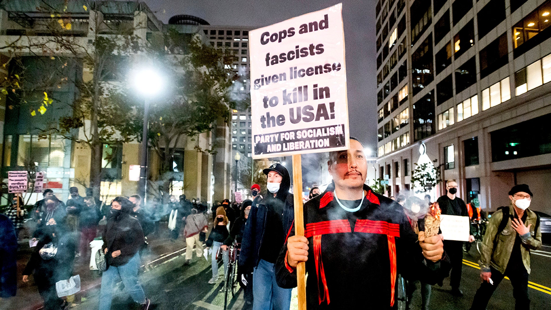 Quanah Brightman marches through Oakland, Calif., Friday, Nov. 19, 2021, with approximately 100 protesters denouncing the acquittal of Kyle Rittenhouse in Kenosha, Wis.