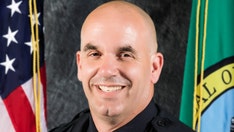 Washington state manhunt on for suspects who shot off-duty officer during attempted burglary