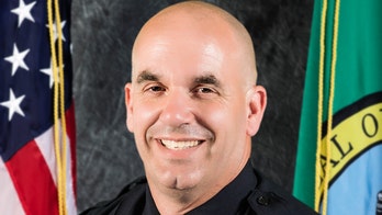 Washington state manhunt on for suspects who shot off-duty officer during attempted burglary