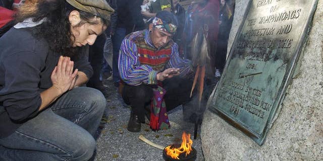 Supporters of Native Americans pause following a prayer during the 38th National Day of Mourning at Coles Hill in Plymouth, Mass., on Nov. 22, 2007. Denouncing centuries of racism and mistreatment of Indigenous people, members of Native American tribes from around New England will gather on Thanksgiving 2021 for a solemn National Day of Mourning observance.