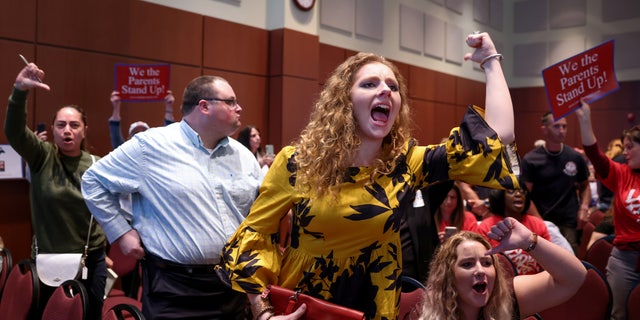 The audience reacts after a Loudoun County School Board meeting was halted by the school board because the crowd refused to quiet down, in Ashburn, Virginia, June 22, 2021.