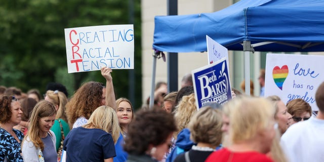 Concerned community members and parents line up outside of the Loudoun County School board headquarters to voice their concerns about Critical Race Theory and other education issues on the docket, in Ashburn, Virginia, U.S. June 22, 2021.