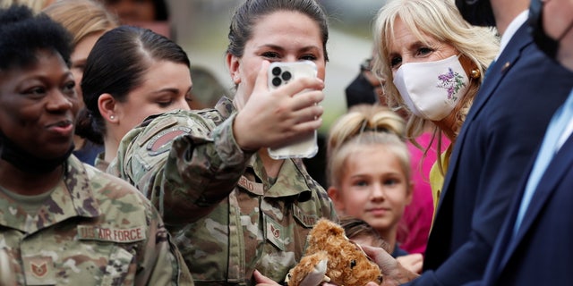 First lady Jill Biden poses for pictures with military members and their families during a gathering at Joint Base Charleston in North Charleston, South Carolina, October 25, 2021.