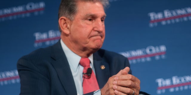 FILE PHOTO: U.S. Senator Joe Manchin (D-WV) participates in a discussion with billionaire philanthropist David Rubenstein, chairman of The Economic Club of Washington, in Washington, U.S., October 26, 2021. REUTERS/Leah Millis/File Photo