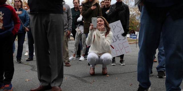 People gather to protest different issues including the board’s handling of a sexual assault that happened in a school bathroom in May, vaccine mandates and critical race theory during a Loudoun County School Board meeting in Ashburn, Virginia, U.S., October 26, 2021. Picture taken October 26, 2021. REUTERS/Leah Millis