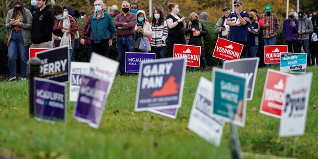 People wait in line on the last day of early voting in the Virginia gubernatorial election in Fairfax, Virginia, U.S., October 30, 2021. REUTERS/Joshua Roberts