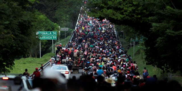 Migrants walk in a caravan heading to Mexico City, in Pijijiapan, Mexico in 2021. The new caravan is expected to be the largest ever.