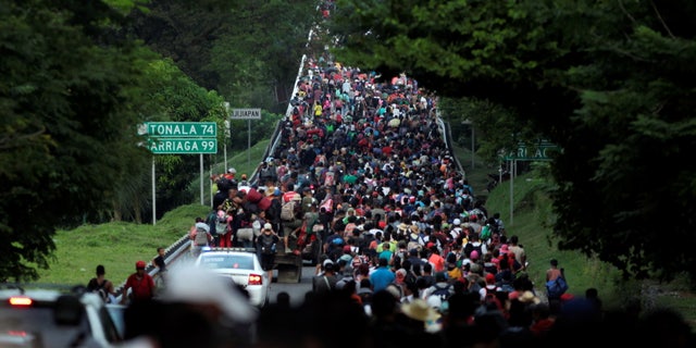 Migrants walk in a caravan heading to Mexico City, in Pijijiapan, Mexico in 2021. The new caravan is expected to be the largest ever.