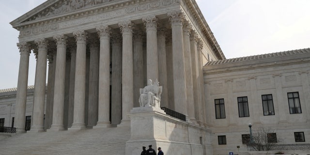 FILE PHOTO: Security guards stand outside the U.S. Supreme Court building in Washington, U.S., March 20, 2019. REUTERS/Leah Millis/File Photo