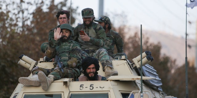 Members of Taliban sit on a military vehicle during Taliban military parade in Kabul, Afghanistan, Nov. 14, 2021. (Reuters/Ali Khara)