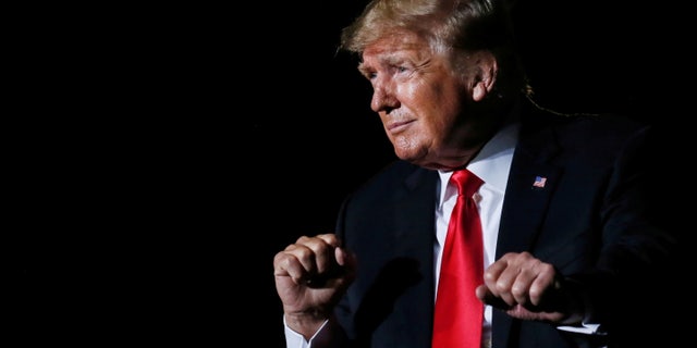 Former President Trump reacts after his speech during a rally at the Iowa State Fairgrounds in Des Moines, Iowa, Oct. 9, 2021.