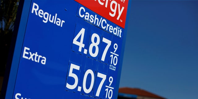 FILE PHOTO: Gas prices grow along with inflation as this sign at a gas station shows in San Diego, California, U.S. November, 9, 2021.  REUTERS/Mike Blake/File Photo/File Photo
