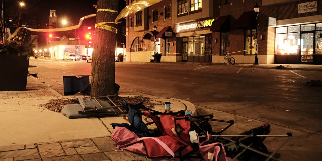 Chairs are left abandoned after a car plowed through a holiday parade in Waukesha, Wisconsin, Nov. 21, 2021. (REUTERS/Daniel Steinle NO RESALES. NO ARCHIVES)