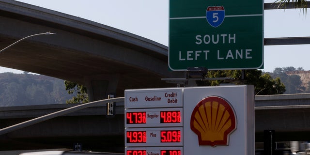 FILE PHOTO: Gas prices grow along with inflation as this sign at a gas station shows in San Diego, California, U.S. November, 9, 2021. 