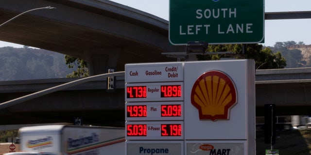 FILE PHOTO: Gas prices grow along with inflation as this sign at a gas station shows in San Diego, California, U.S. November, 9, 2021. REUTERS/Mike Blake/File Photo