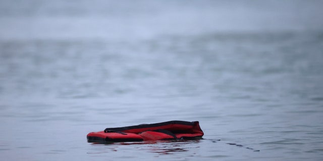 A life jacket is left after a group of more than 40 migrants get on an inflatable dinghy, to leave the coast of northern France and to cross the English Channel, near Wimereux, France, November 24, 2021. REUTERS/Gonzalo Fuentes