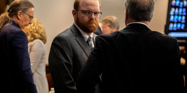 Travis McMichael looks back at his mother and sister in the courtroom after the jury convicted him for the murder of Ahmaud Arbery in the Glynn County Courthouse, in Brunswick, Georgia, Nov. 24, 2021. (Stephen B. Morton/Pool via REUTERS)