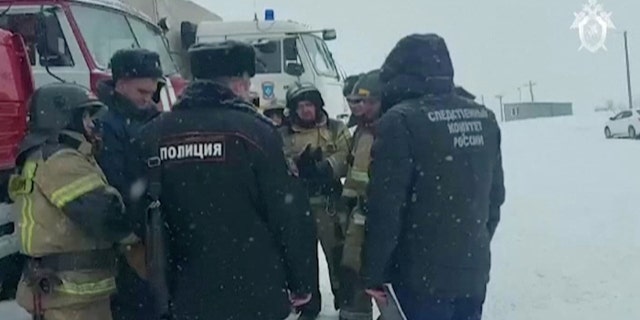 A still image taken from video shows Investigators and rescuers during a rescue operation following a fire in the Listvyazhnaya coal mine in the Kemerovo region, Russia, November 25, 2021. (Russian Investigative Committee/Handout via REUTERS)